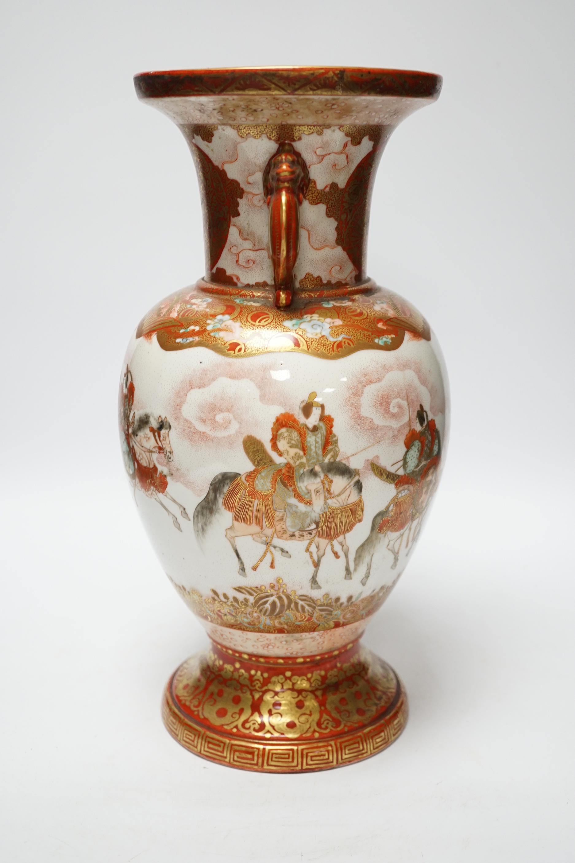 A Japanese Kutani porcelain twin handled vase, Meiji period, decorated with warriors on horseback, 34.5cm high